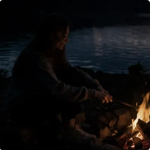 Brighten or Darken Image Online Free Tool demo showing the girl in dark evening next to fire on beach being illuminated with a dodge brush.